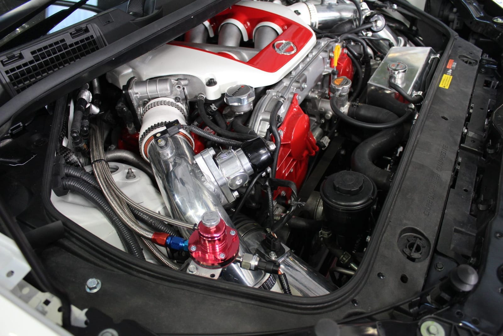 Tuned Nissan GT-R engine bay with Nismo parts and polished intake pipes