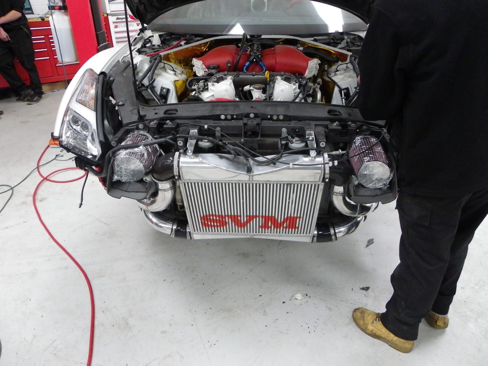 Nissan GT-R with an SVM branded front-mount intercooler being fitted