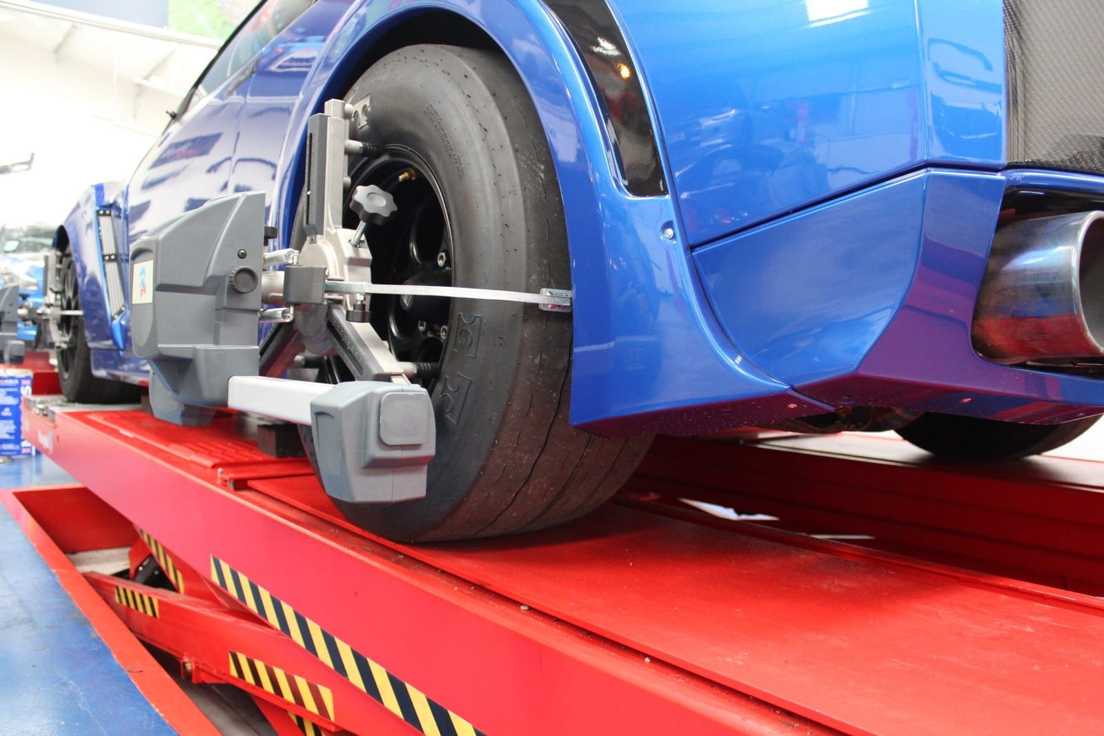 Wheel alignment clamp and sensor fitted to a GT-R rear wheel